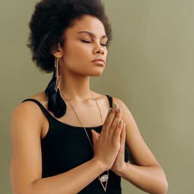 Focused individual in a seated meditation yoga pose.
